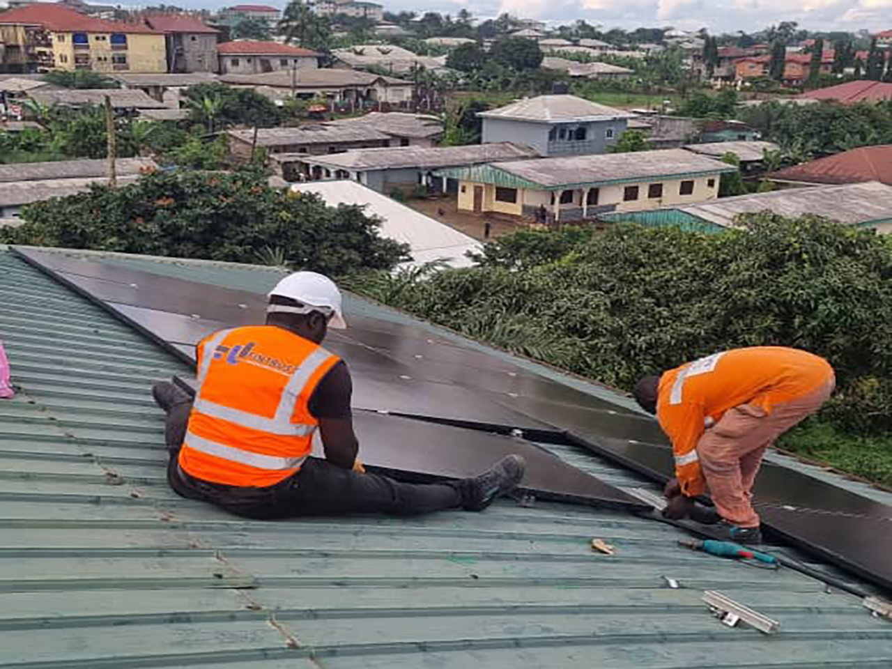 fintrust cameroon solar-panels with men working